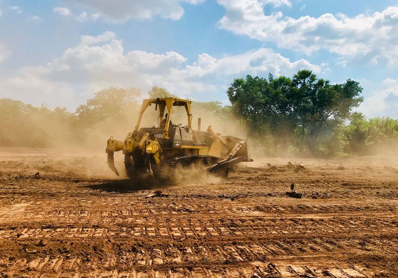 Heavy equipment working a cleared lot
